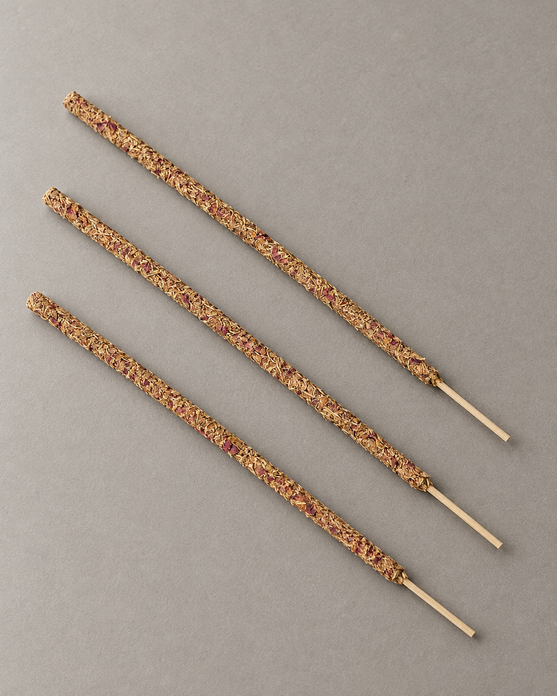 Three representative rose incense sticks showing the full incense body and bamboo handles.