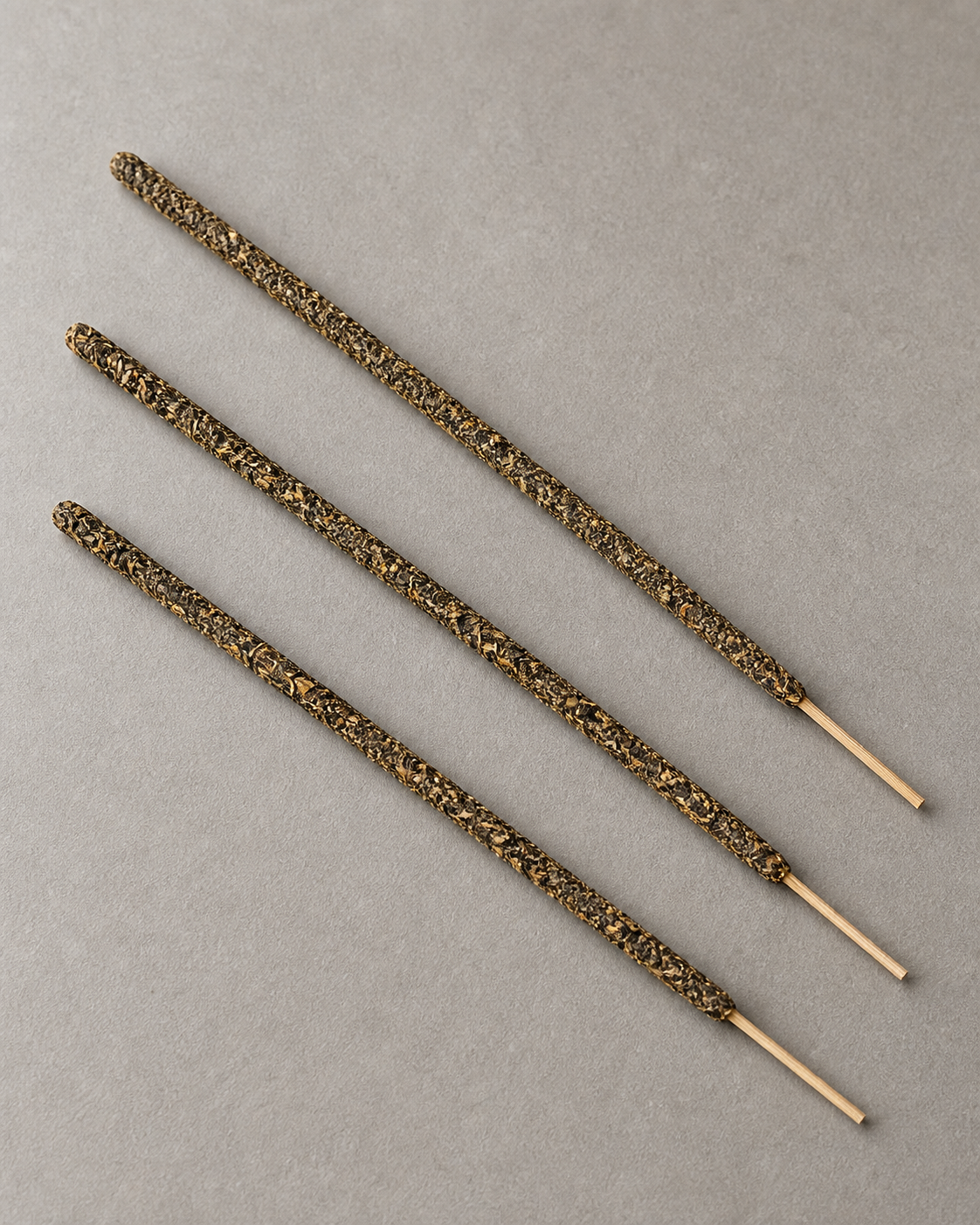 Three representative Rain-Steeped Tea incense sticks showing the full incense body and bamboo handles.